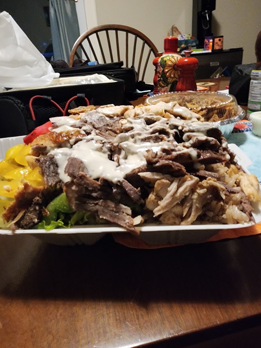 A loaded shawarma platter on a dining table from a second angle